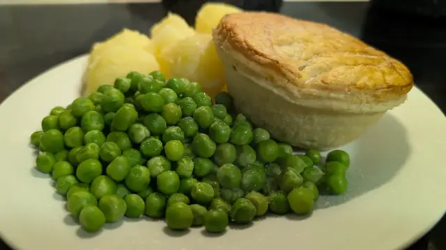 Chicken pie, boiled potatoes and peas