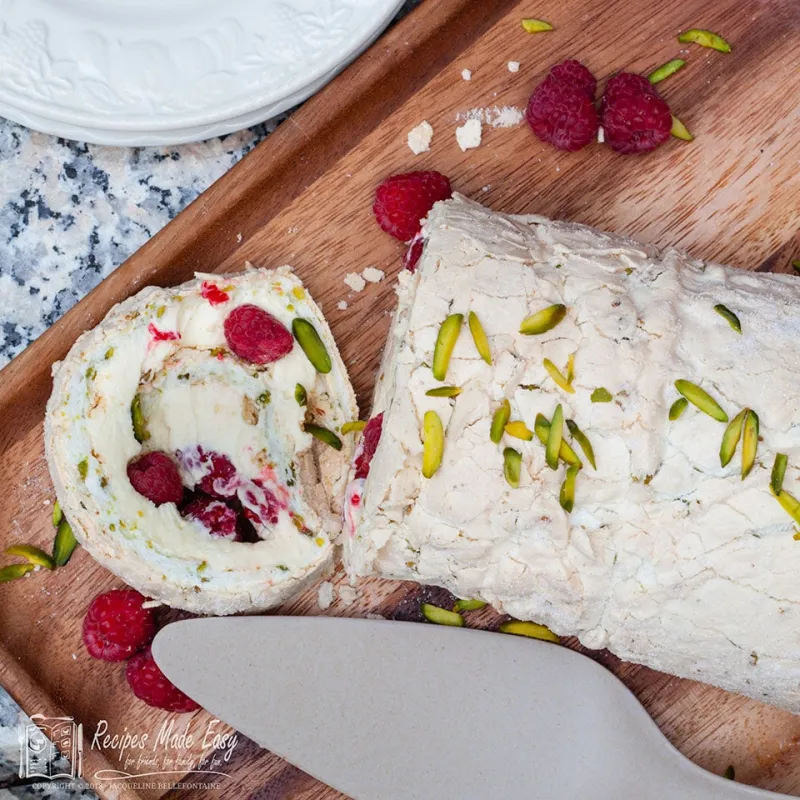 Pistachio, raspberry and lemon meringue roll
