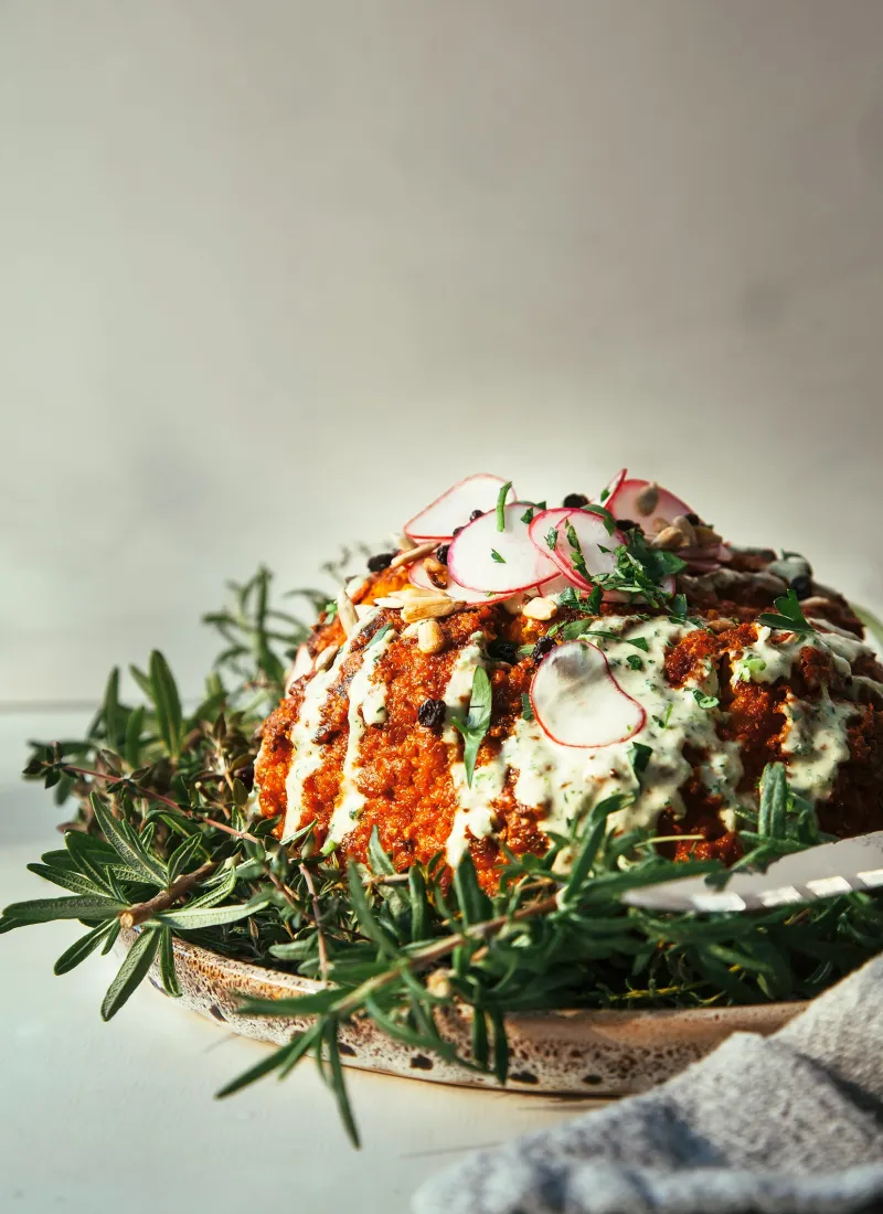 Romesco Roasted Whole Cauliflower with Herbed Tahini Cream