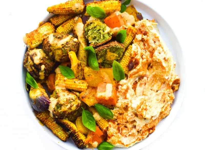 This easy roasted corn, yellow pepper & falafel bake is a delicious roasting tin dinner. Serve it with hummus for a simple weeknight dinner that's dairy-free, plant-based & vegan.